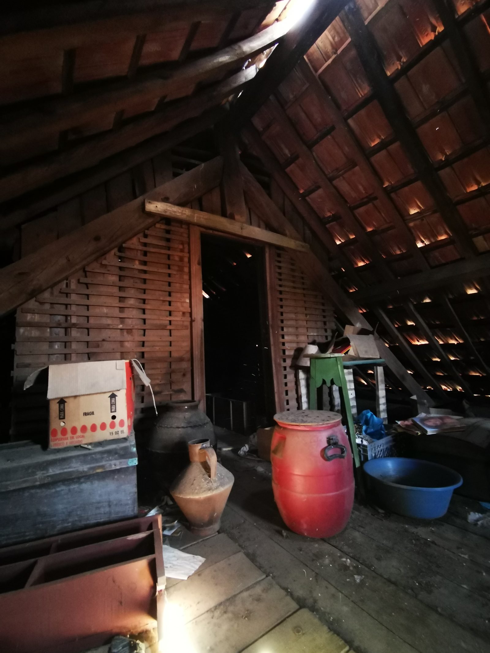 The attic, full of old storage — jugs, barrels, decades of things left behind