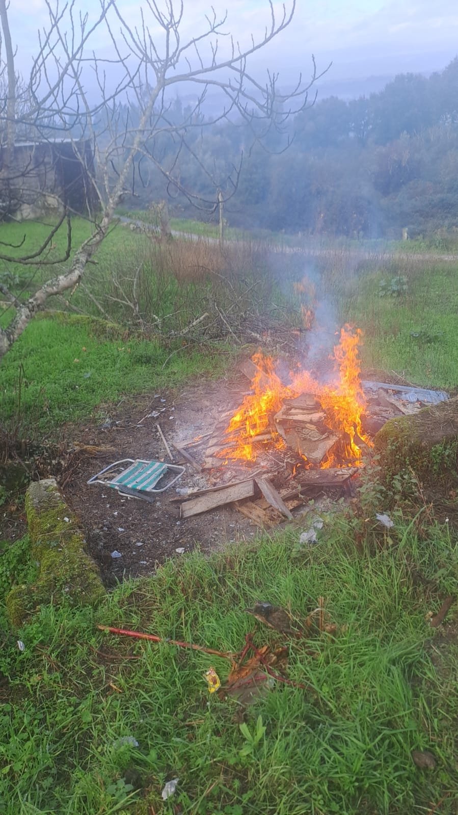 Burning a pile of old wood and debris cleared from the house, November 2024